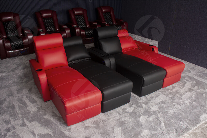 movie room with couches and theater recliner chairs